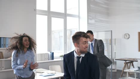 excited business team dancing in the office