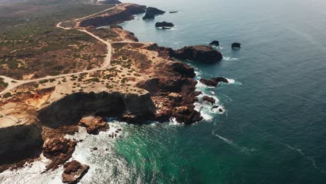 drone shot of the rocky cliffs along the coast of portugal