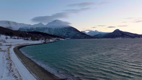 landscape shot of snow-capped mountains and the sea on the coast of norway