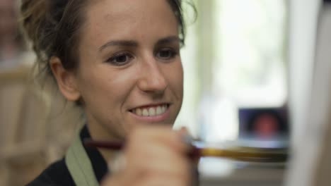 cheerful woman drawing a picture at art studio