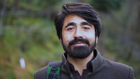 Close-up-shot-of-a-young-Kashmiri-male---A-Kashmiri-man-smiling-toward-the-camera