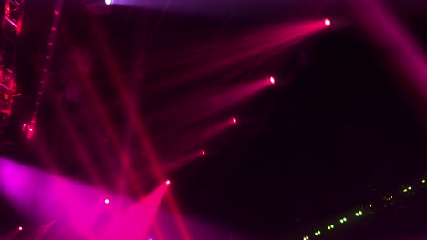 plenty of searchlights with reddish beams create a stunning light show