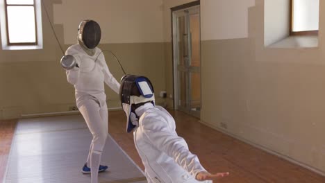 fencer athletes during a fencing training in a gym