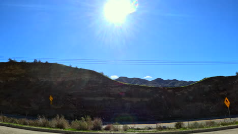 passenger window view of the santa susana mountains along route 14 in southern california