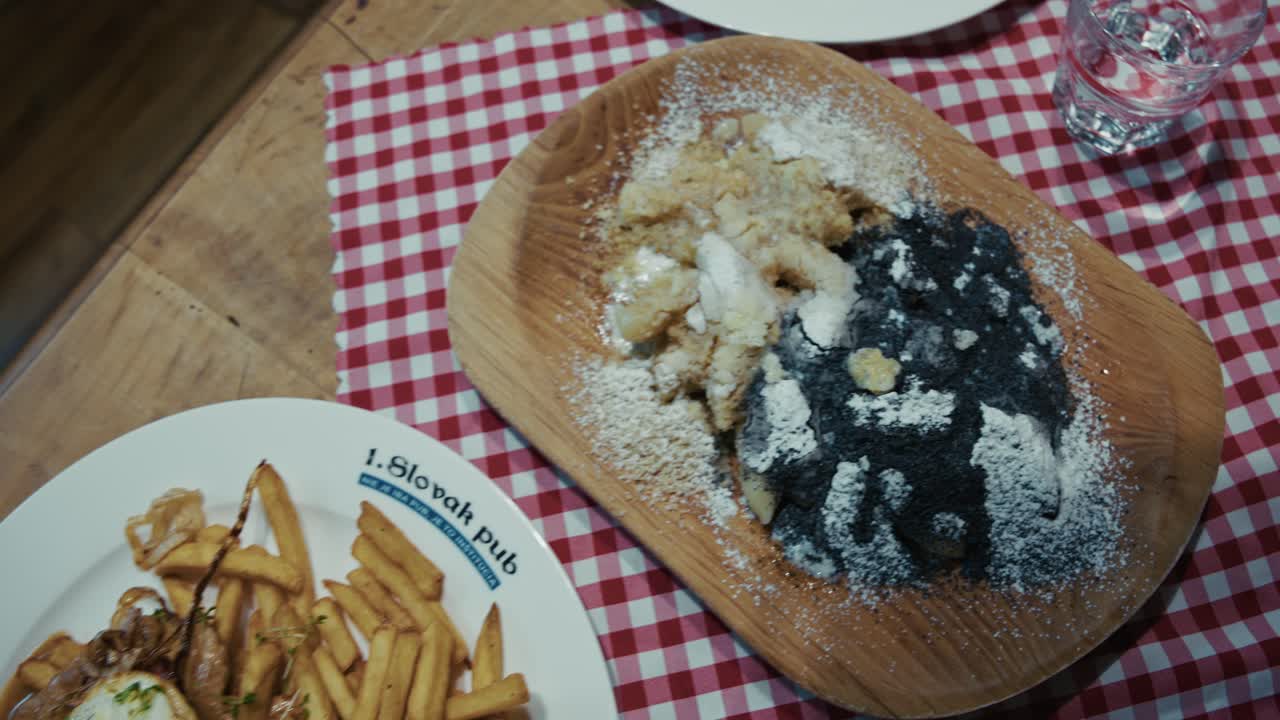 Slovak meal with fries, meat, egg, and sauce on a plate at a Bratislava restaurant