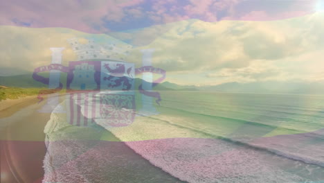 digital composition of waving spain flag against aerial view of the beach