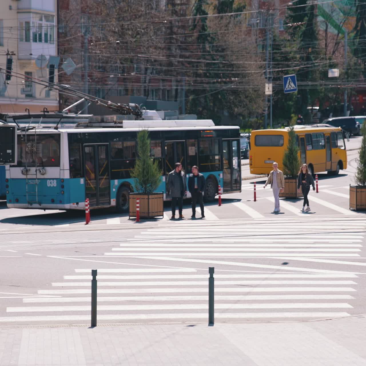 Pedestrians cross the street