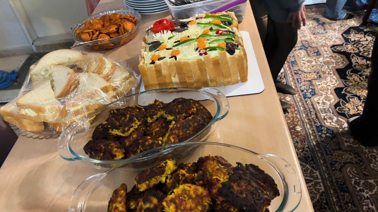 Persian party thanksgiving buffet with grilled sosis bandari adas polo sandwich cake and creamy kashke bademjan Traditional handmade dishes featuring eggplant garlic tangy yogurt and fermented dairy