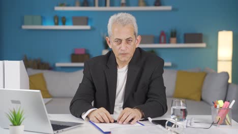 home office worker man making negative gesture at camera.