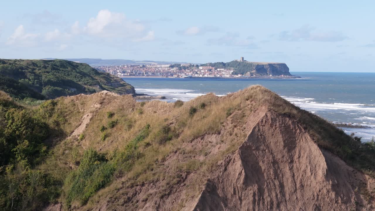 aerial drone footage of Cornelian Bay, Scarborough with blue sky and ocean and big waves