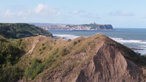 aerial drone footage of cornelian bay, scarborough with blue sky and ocean and big waves