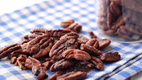 Tasty-pecan-nut-on-a-wooden-board-on-white--table-,