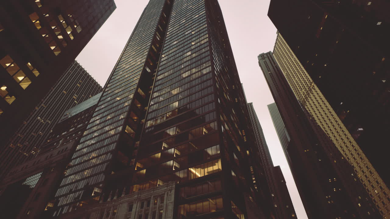 Tall city buildings reflecting modern architecture under cloudy sky