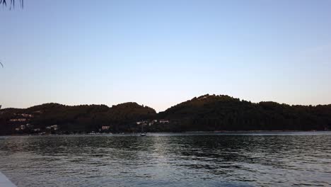 Static-Shot-Of-A-Commercial-Plane-Landing-Over-The-Ocean-At-Skiathos,-Greek-Islands