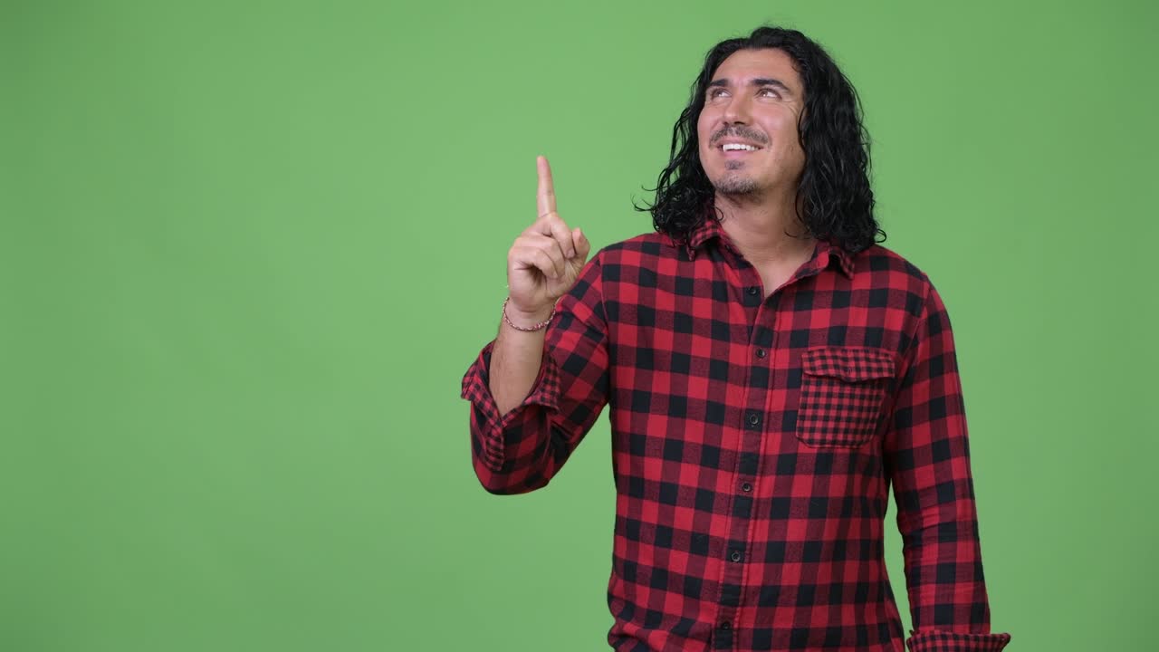 Handsome hipster man pointing finger up