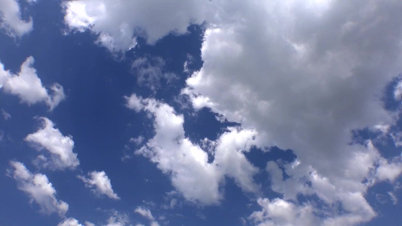 White Clouds Drifting Across a Clear Blue Sky