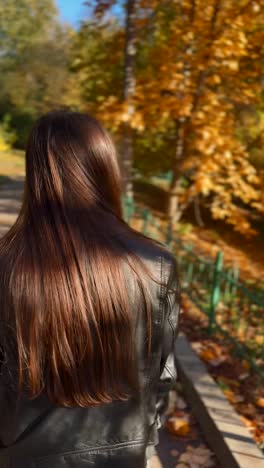 woman walking in autumn park