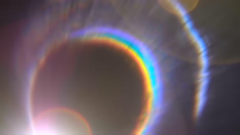 colorful flares in lens from a bright light source on a black background