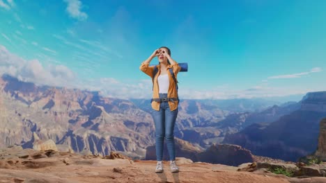 full body of asian female hiker with mountaineering backpack making binoculars gesture looking at something then saying wow while traveling at the top of mountain