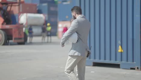 back view. businessman and business partner walking to check cargo loading process and shipping process or progress of the company for invest in new projects in cargo transport or expand the business.