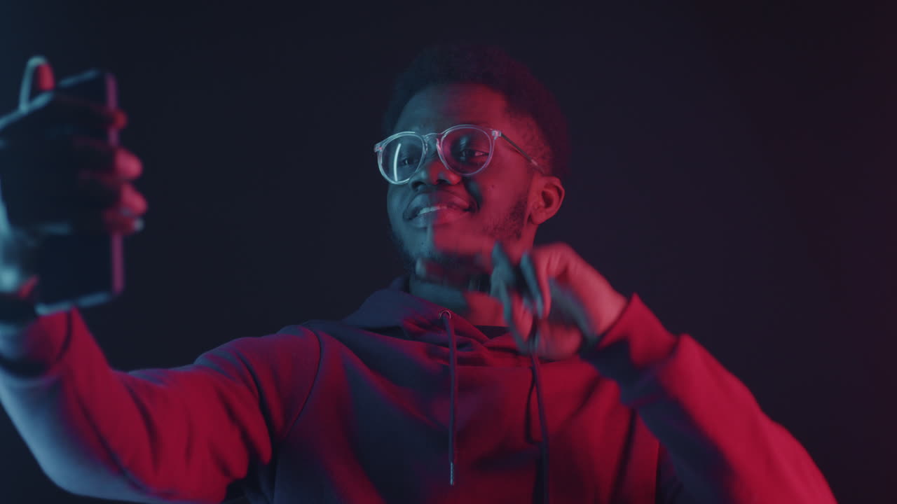 Man Taking a Selfie in Neon Light