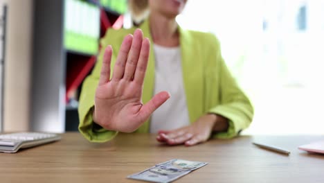 woman refusing money or a bribe