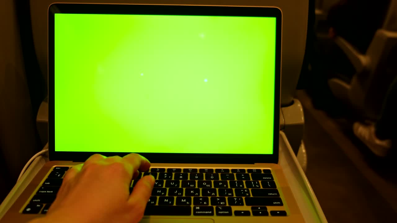 punto de vista de una mujer trabajando en una computadora portátil pantalla verde dentro del tren