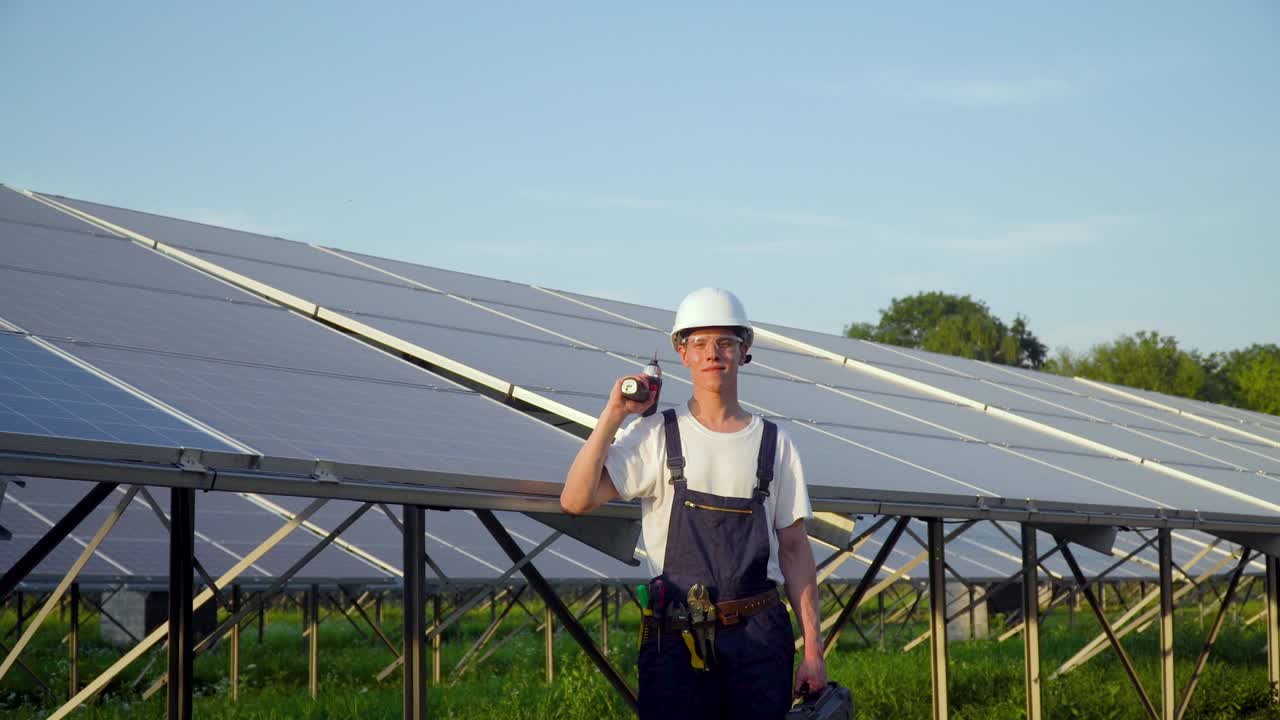 The man is checking the solar battery if it works well. Green energy concept