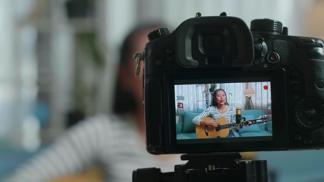 Woman Playing Guitar for Online Video