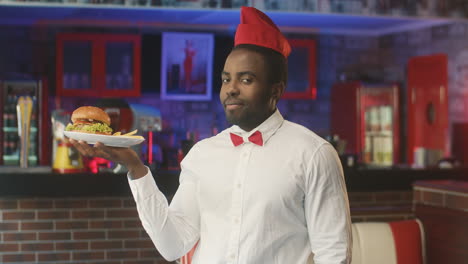 waiter holding a delicious burger