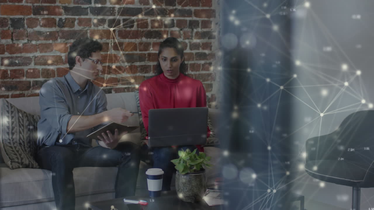 Animation of networks of connections over business people using laptop in office