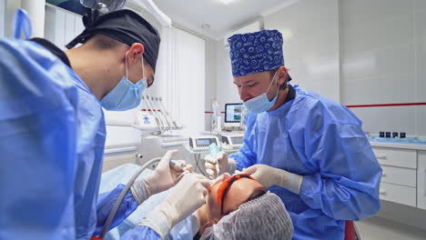 woman at the dentist's visit. professional stomatologist treats patient's teeth. contemporary medical equipment in a dental clinic.