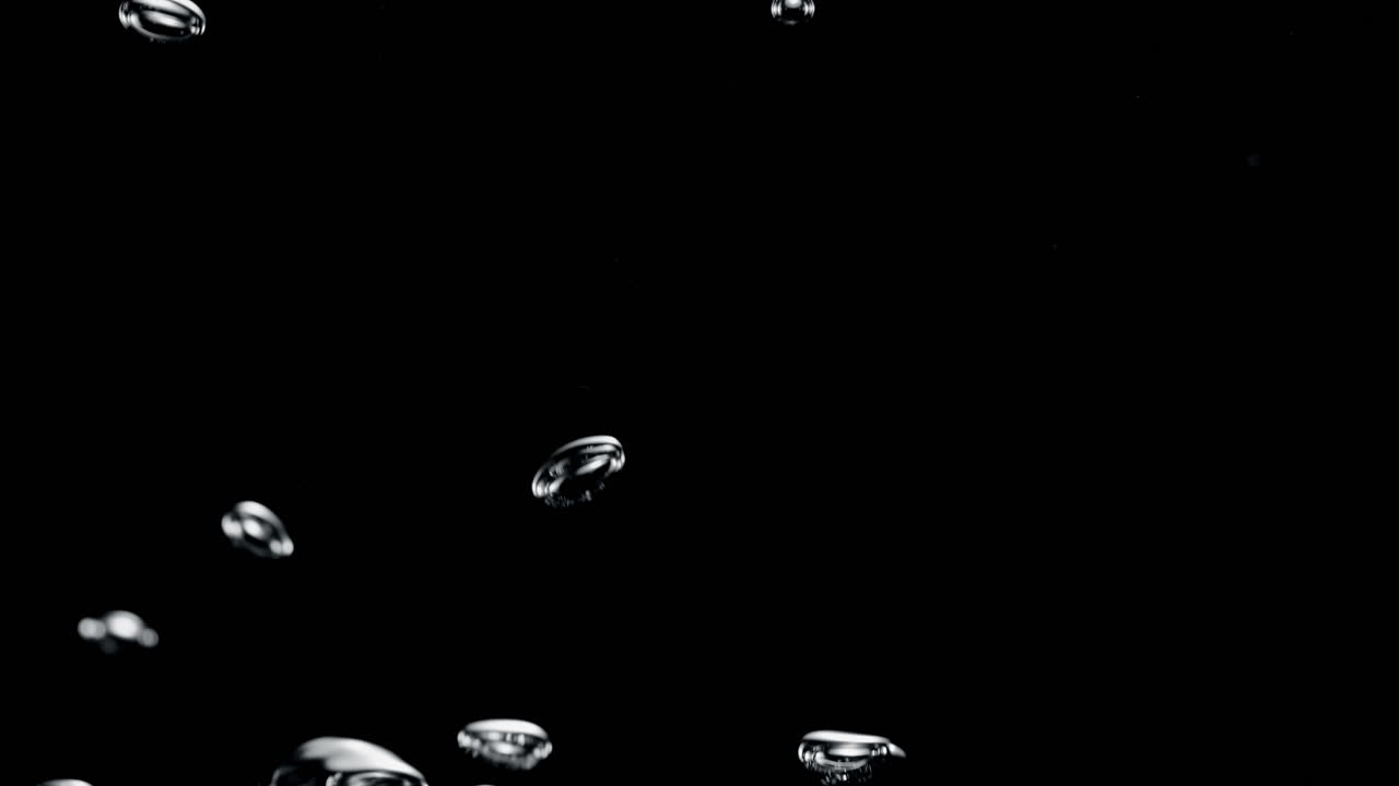Irregular Shaped Air Bubbles Rise From The Bottom Up In The Black Fluid In Slow Motion and Macro