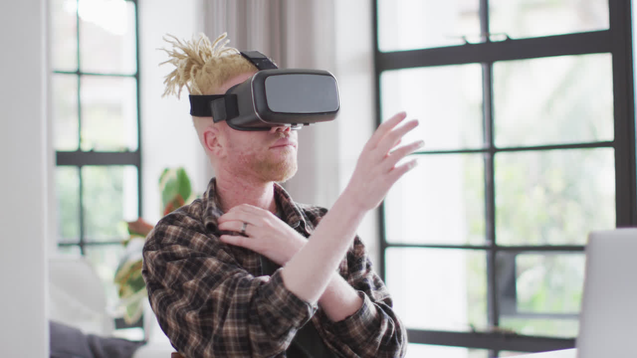 Albino african american man with dreadlocks using vr headset