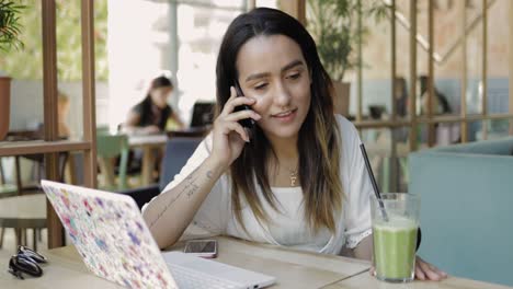 young woman sitting listening to a mobile call