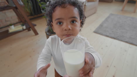 POV of Adorable Black Little Boy Drinking Milk