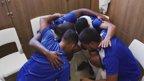 soccer players motivating in the locker room