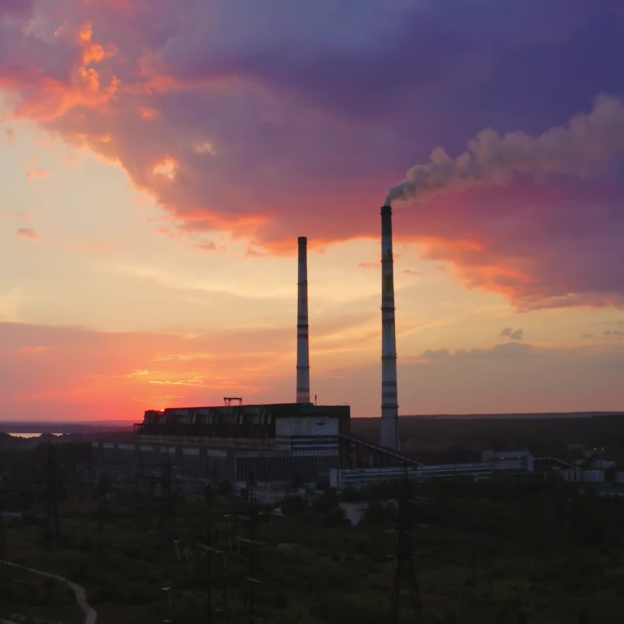 Power plant by sunset in the landscape with lake. Timelapse video