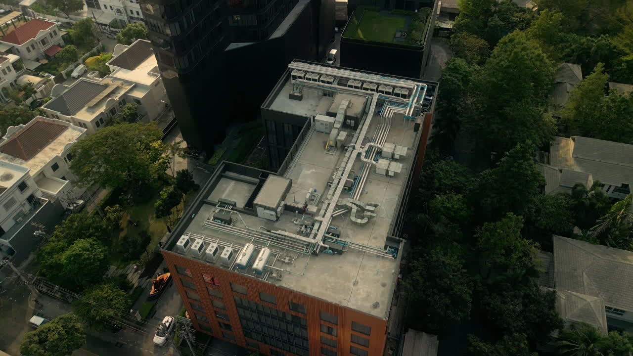 Aerial view of a building rooftop with HVAC system in an urban environment
