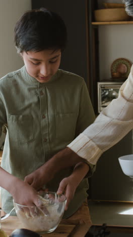 father and son baking together in the kitchen