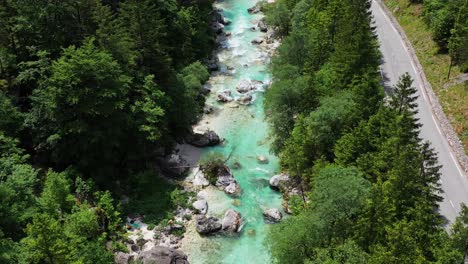 Aerial-view-of-beautiful-turquoise-water-river-flowing-along-the-mountain-road-of-national-park