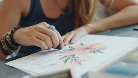 woman artist painting a flower