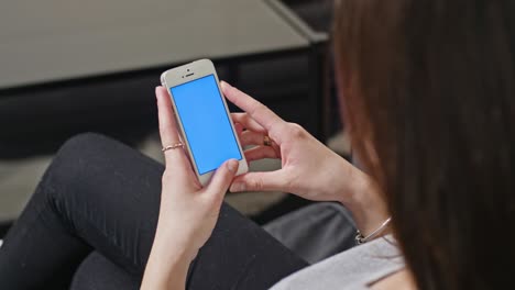 woman is holding smartphone with blue screen