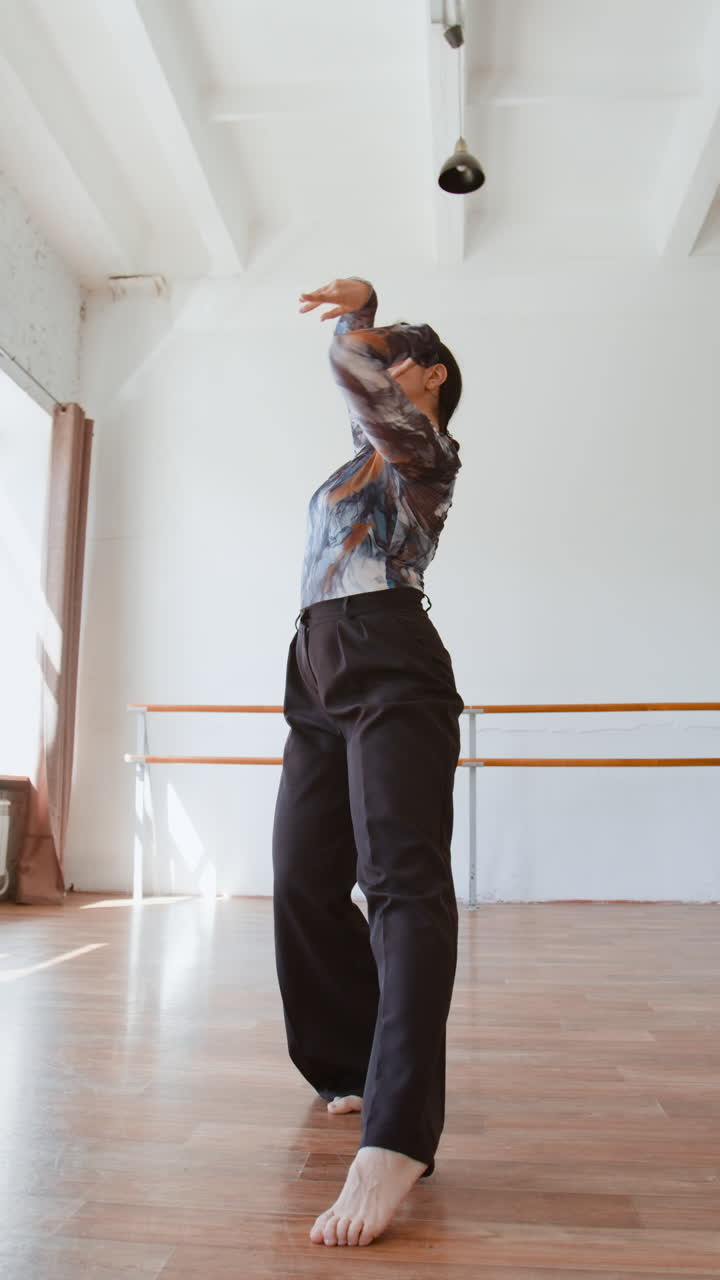 Woman Practicing Contemporary Dance Movements in a Studio