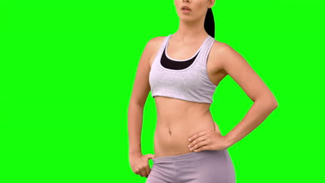 athletic woman tossing hair on green screen