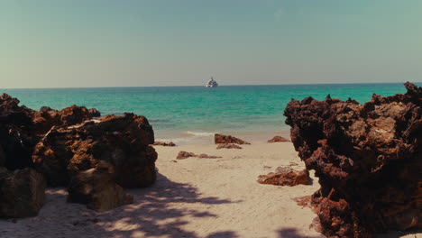 tropical beach with yacht
