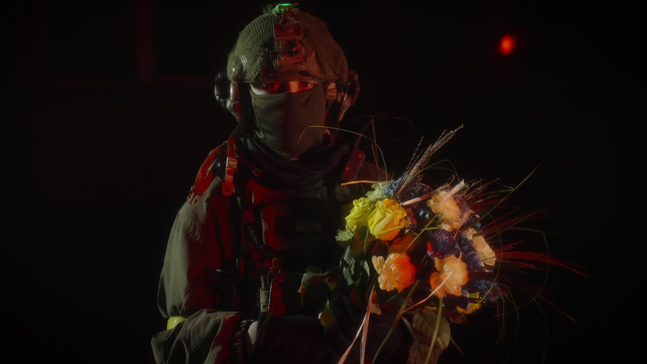 Soldier holding flowers at night