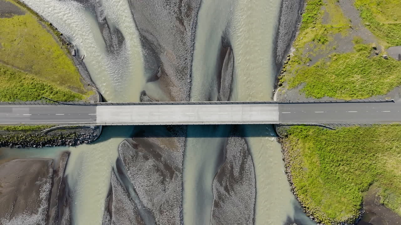 Aerial View of a Van Driving Across a Bridge Over a Braided River