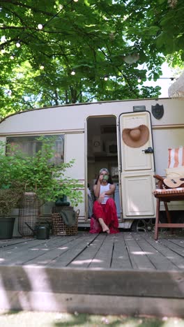 woman relaxing on a camping trailer deck