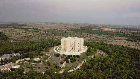 Drone-flying-backwards-away-from-Castel-del-Monte-in-the-south-of-Italy-in-the-early-morning-in-4k